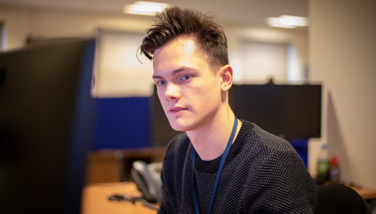 Member of staff sat in front of a computer