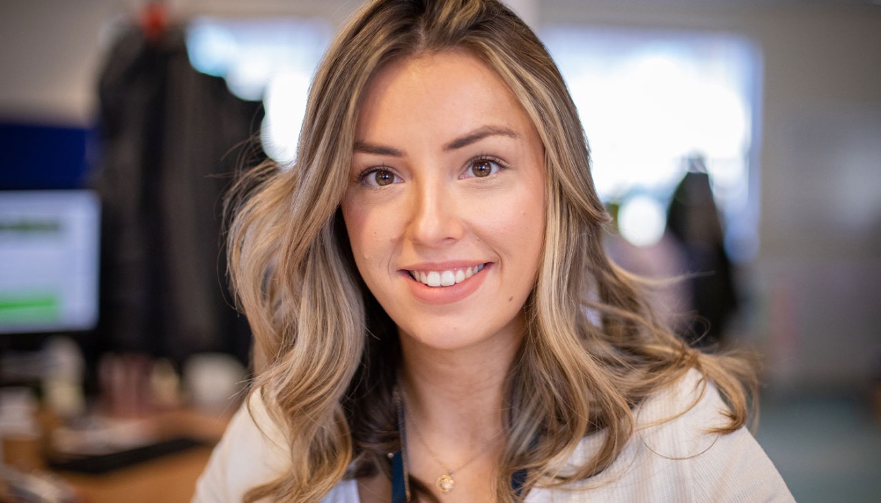 Member of staff looking directly into camera smiling