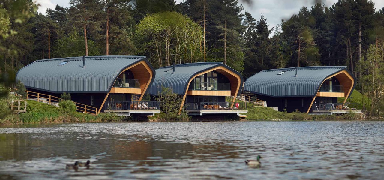 view of Elveden Lake with the waterside lodges in the background