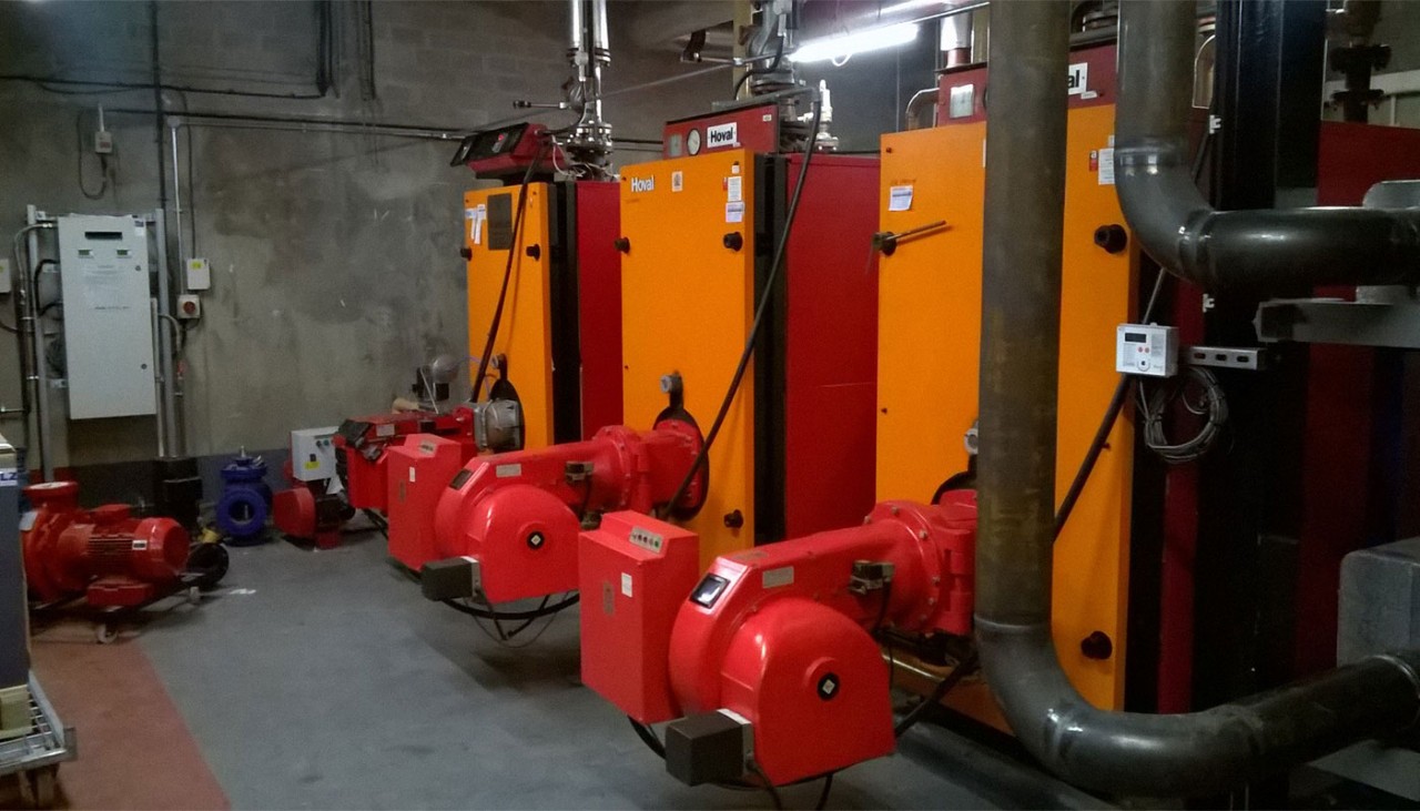 Three big red and orange machines used for converting energy