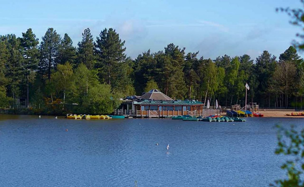 View of lake with the beach, Pancake House and forest in the distance