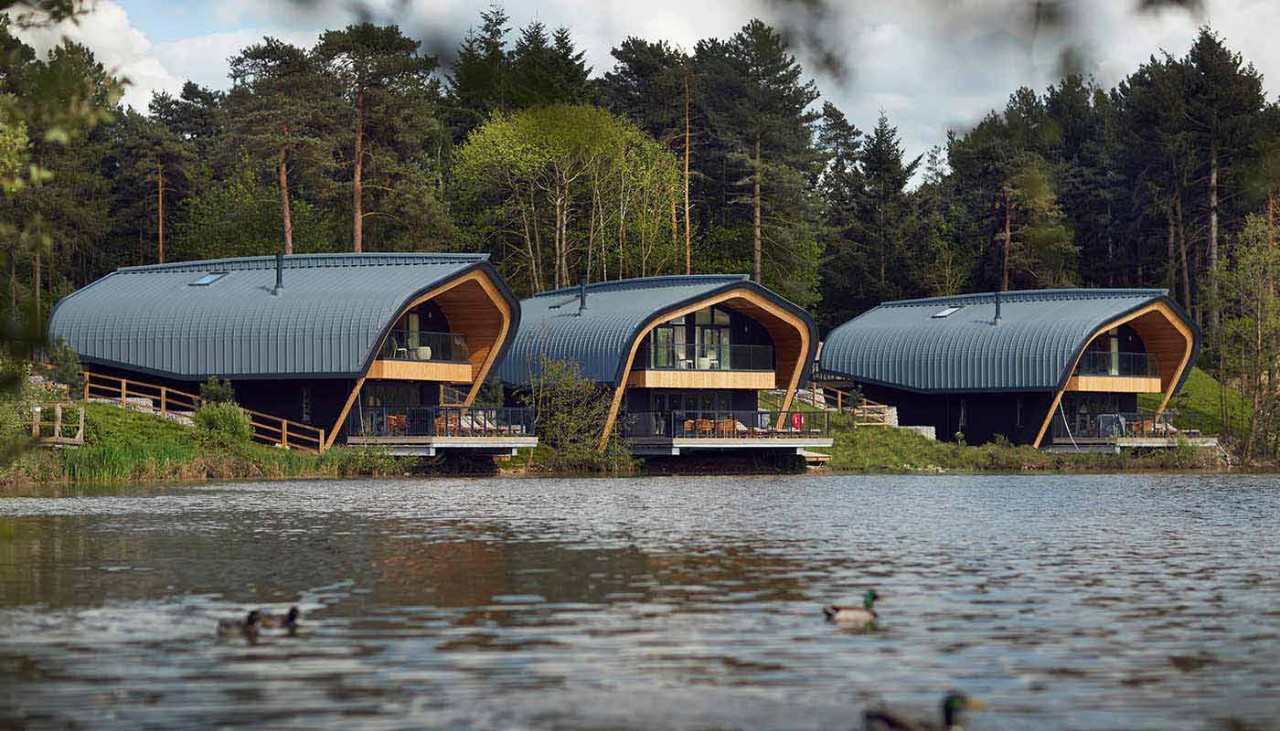 view of Elveden Lake with the waterside lodges in the background