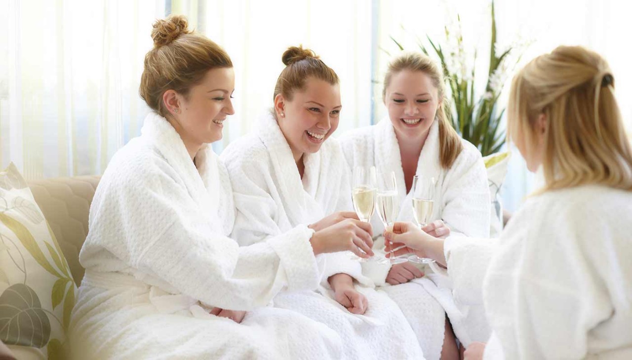 Four guests sat in robes in the Aqua Sana hideaway room drinking Champagne 