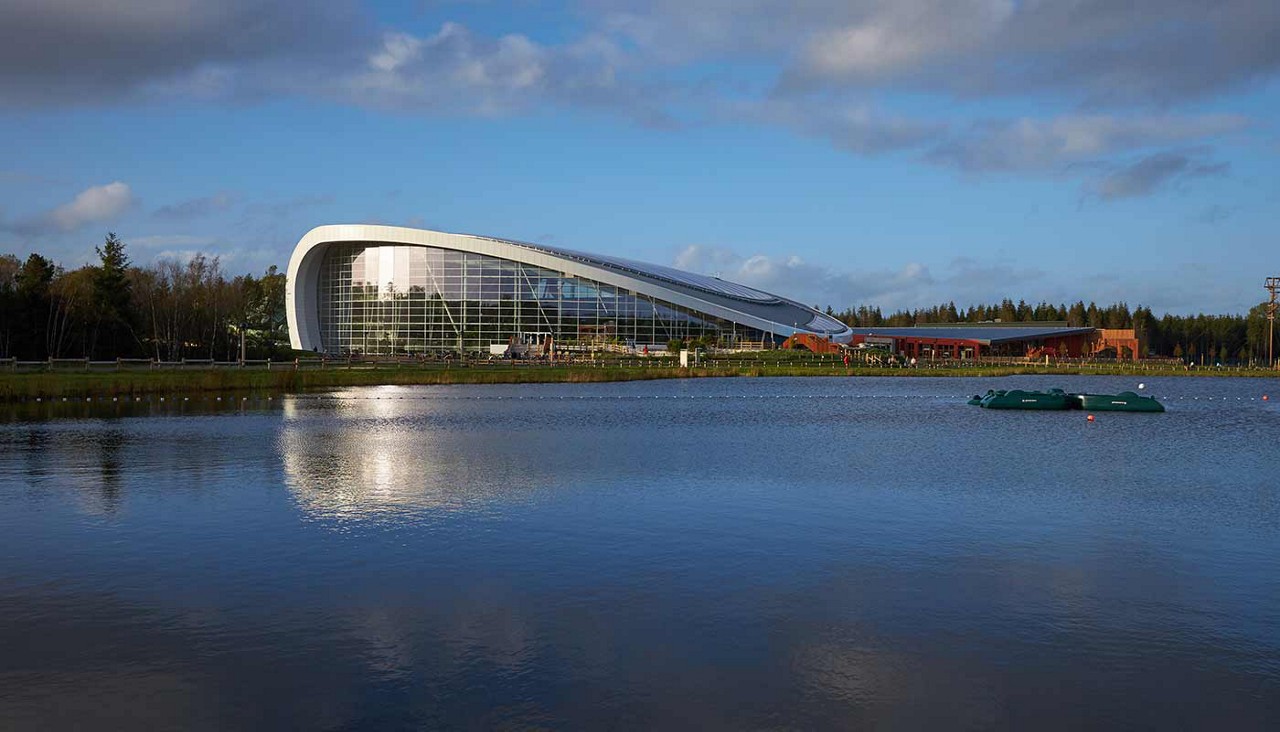 Exterior view of Subtropical Swimming Paradise with lake in front of it at Longford Forest