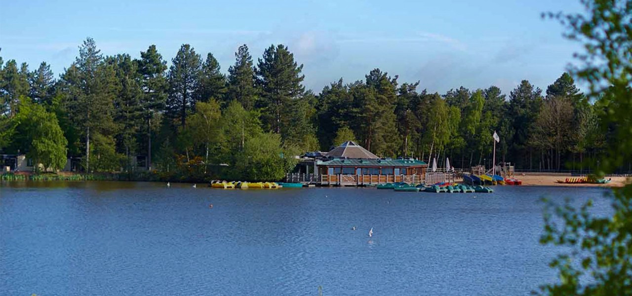 View of lake with the beach, Pancake House and forest in the distance