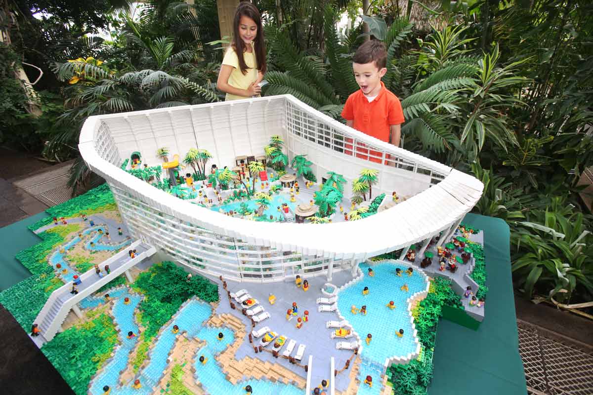 Two children looking at a Lego model of the Subtropical Swimming Paradise