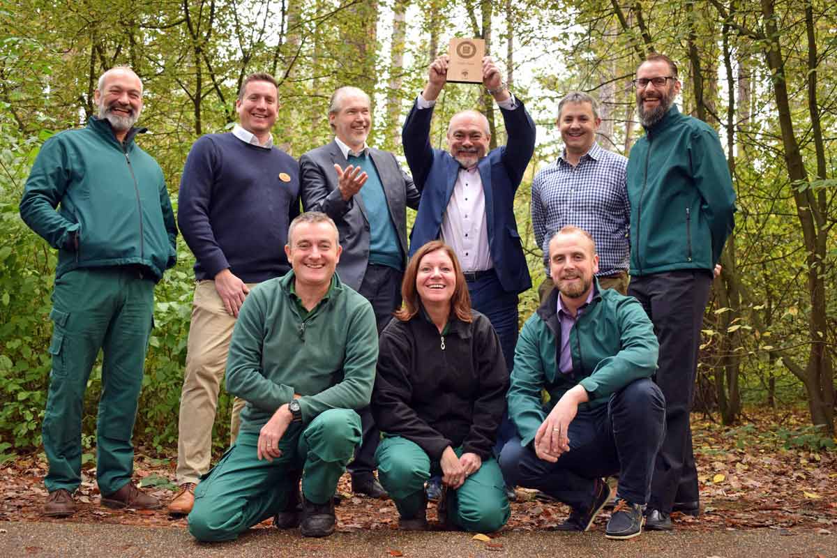 Martin Dolby and staff members in the forest with an award from the wildlife trust