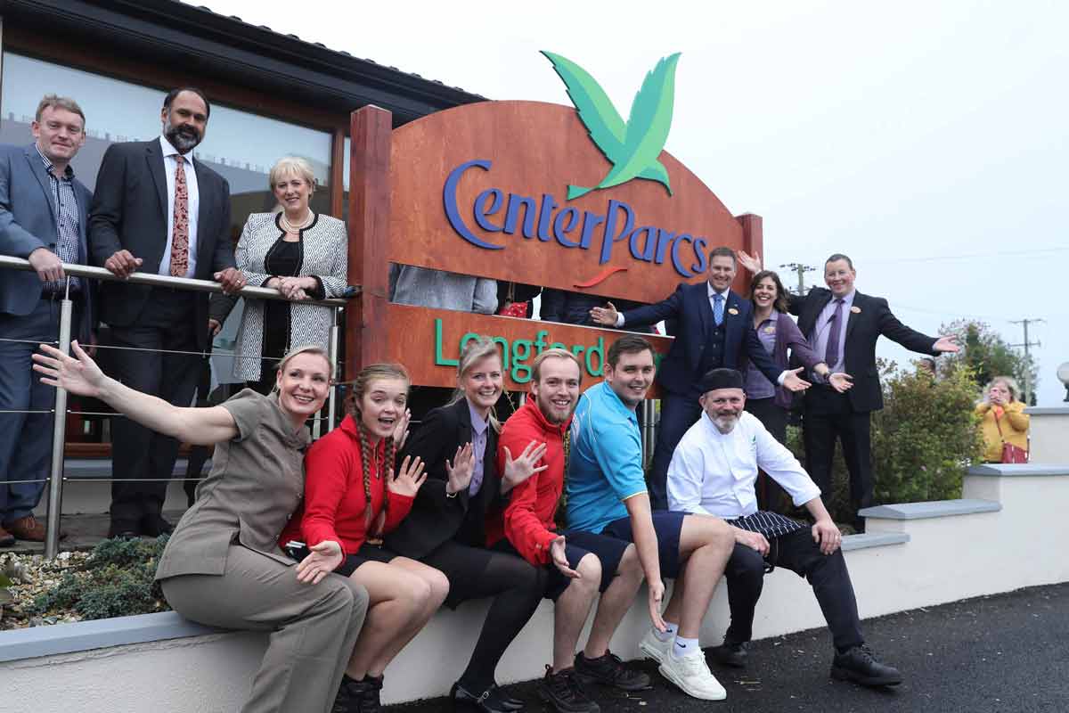 group of staff members in front of Longford Forest Center Parcs sign 