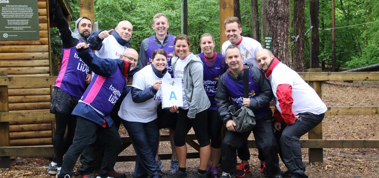 A group of people wearing sports gear and vests with the together for short lives logo on it