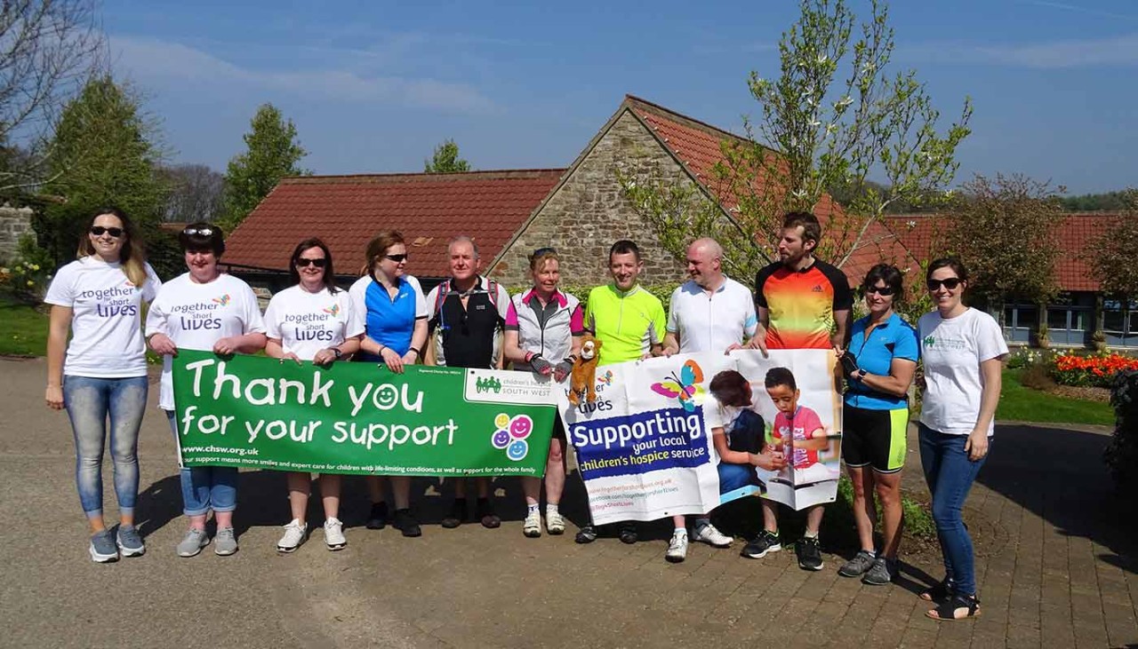 Fundraisers holding charity banner